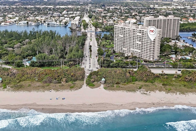 birds eye view of property featuring a water view and a view of the beach