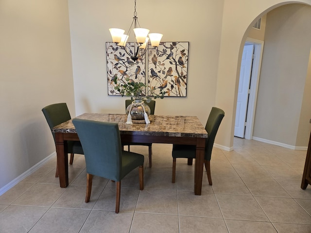 tiled dining space with an inviting chandelier