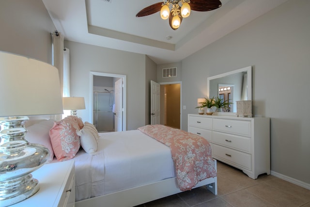 bedroom featuring light tile patterned floors, ceiling fan, and a tray ceiling