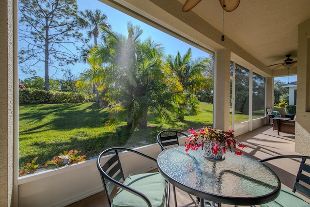 sunroom / solarium with ceiling fan and a healthy amount of sunlight