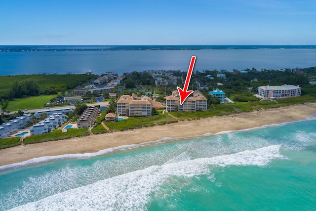 birds eye view of property featuring a view of the beach and a water view