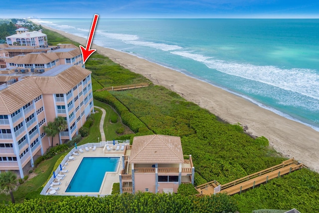 birds eye view of property with a beach view and a water view