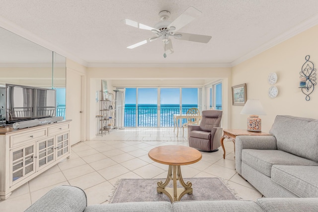 living room with light tile patterned flooring, ceiling fan, crown molding, and a water view