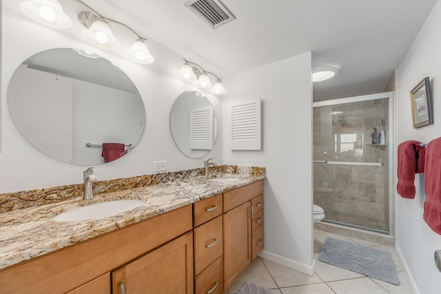 bathroom with toilet, a shower with door, vanity, and tile patterned floors