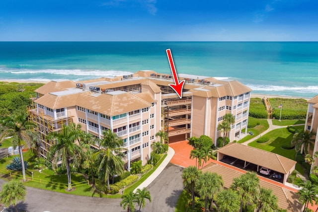 drone / aerial view featuring a view of the beach and a water view