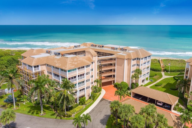 drone / aerial view featuring a beach view and a water view