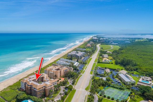 birds eye view of property with a beach view and a water view