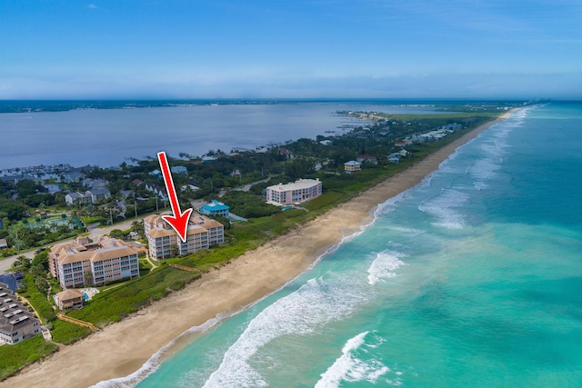 birds eye view of property with a beach view and a water view