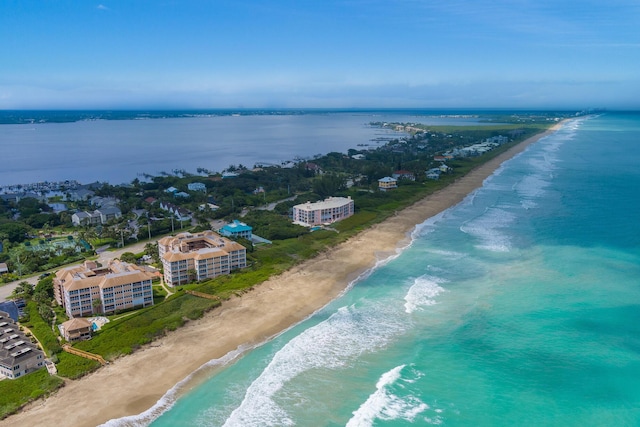 birds eye view of property with a beach view and a water view