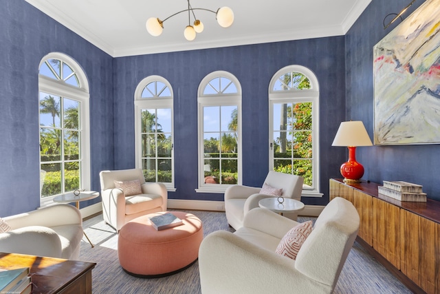 sitting room with an inviting chandelier and ornamental molding