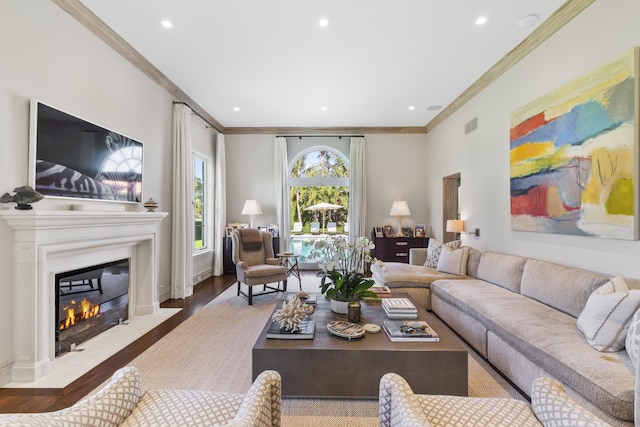 living room with ornamental molding and hardwood / wood-style floors