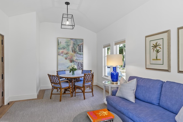 dining space featuring vaulted ceiling and light hardwood / wood-style floors