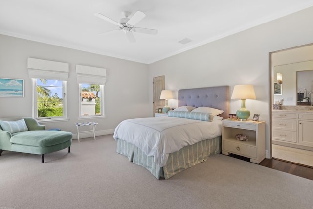 carpeted bedroom with ornamental molding and ceiling fan