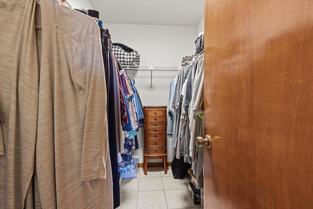 walk in closet with light tile patterned floors