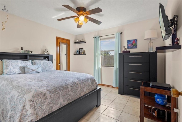 bedroom featuring light tile patterned floors, a textured ceiling, and ceiling fan