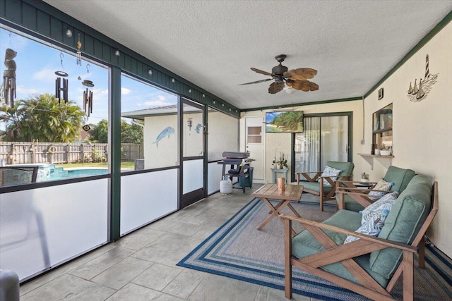 sunroom featuring ceiling fan