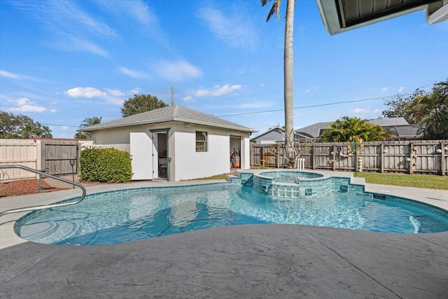 view of swimming pool with an outdoor structure and an in ground hot tub