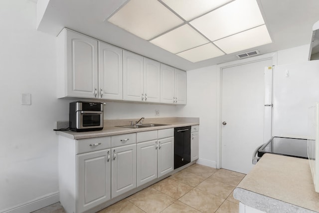 kitchen with dishwasher, sink, white cabinets, white refrigerator, and light tile patterned floors