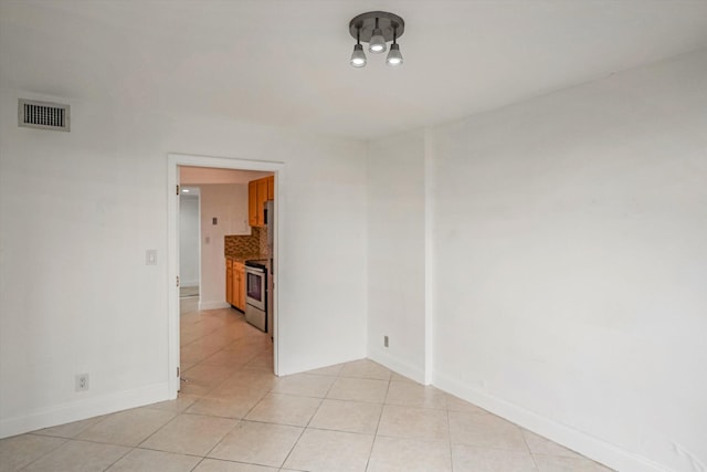 empty room with light tile patterned floors