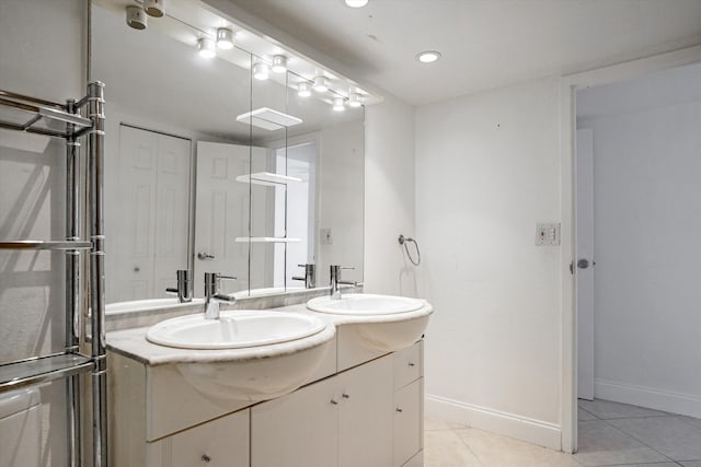 bathroom featuring tile patterned flooring and vanity