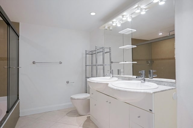 full bathroom with toilet, vanity, tile patterned floors, and enclosed tub / shower combo