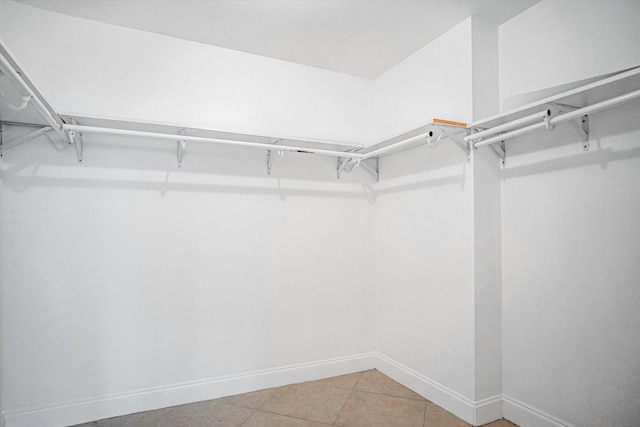 walk in closet featuring tile patterned flooring