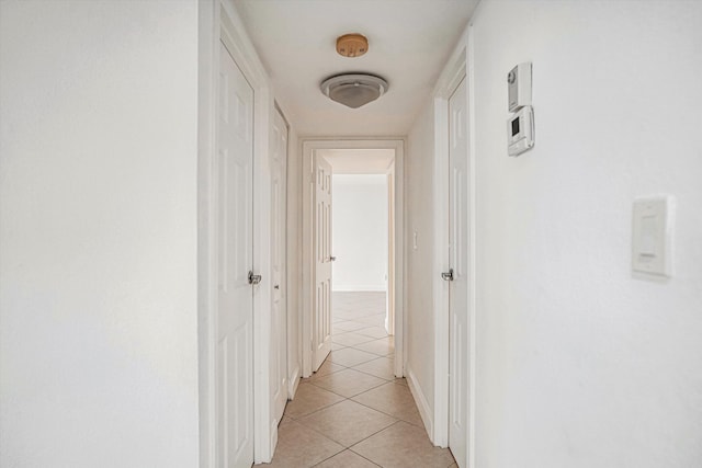 hall featuring light tile patterned floors