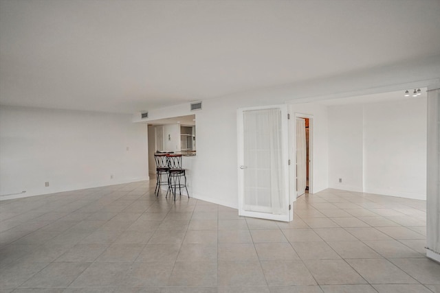 unfurnished room featuring light tile patterned flooring