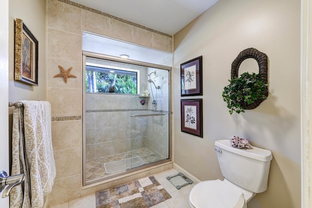 bathroom with walk in shower, tile patterned floors, and toilet