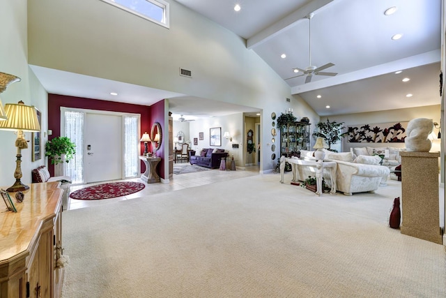 living room featuring high vaulted ceiling, ceiling fan, beamed ceiling, and light colored carpet