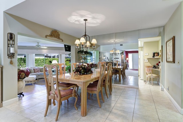 dining area featuring ceiling fan with notable chandelier and light tile patterned floors