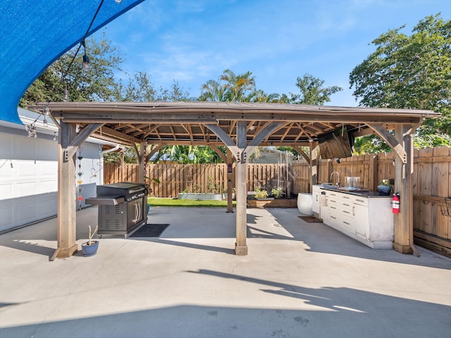 view of patio with a gazebo and a garage