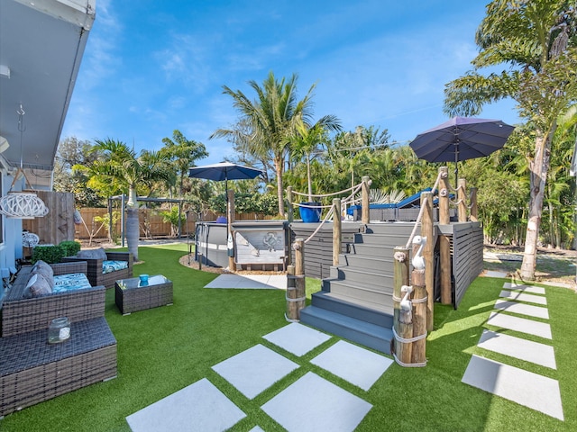 view of play area with a patio, an outdoor living space, a pool, and a lawn