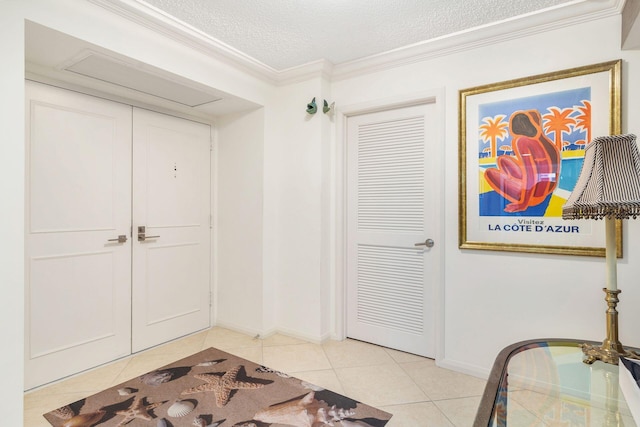 interior space with crown molding, light tile patterned floors, and a textured ceiling