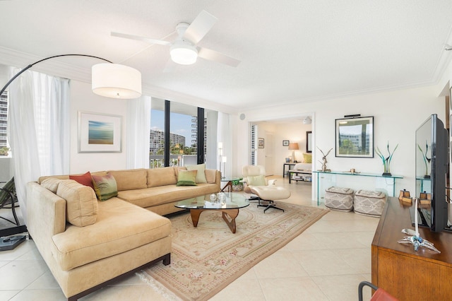 living room with ceiling fan, ornamental molding, a textured ceiling, and light tile patterned floors