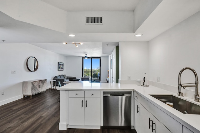 kitchen featuring dishwasher, dark wood-type flooring, white cabinets, sink, and kitchen peninsula