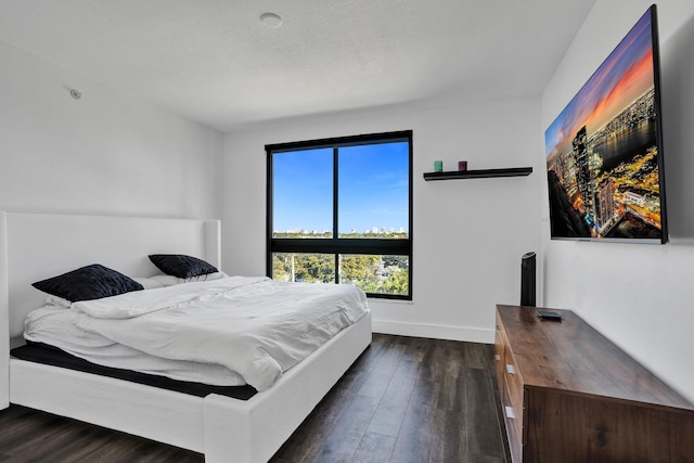 bedroom with dark wood-type flooring