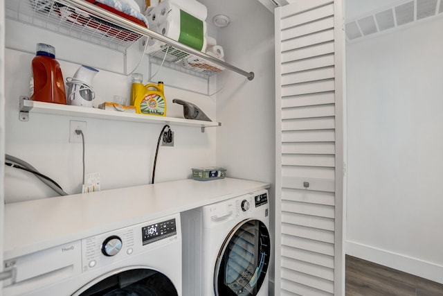 clothes washing area with washer and clothes dryer and dark hardwood / wood-style flooring