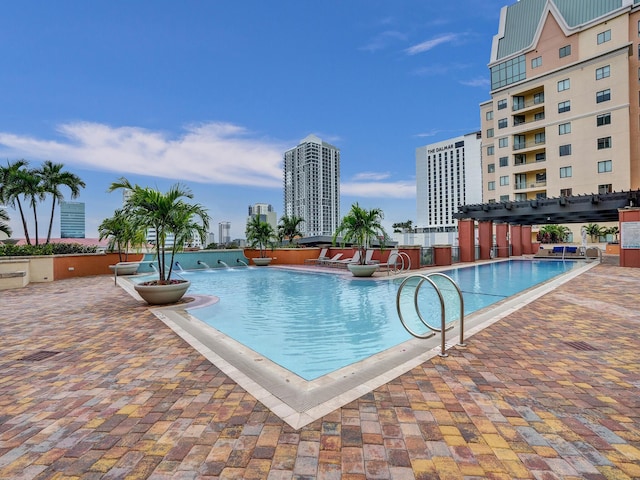 view of pool with a pergola and a patio