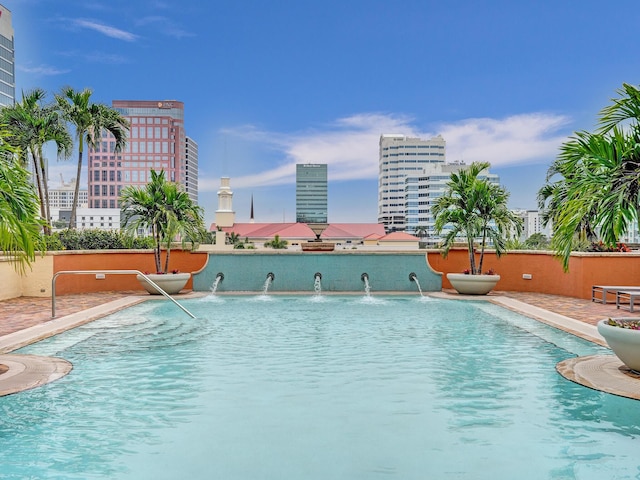 view of swimming pool with pool water feature