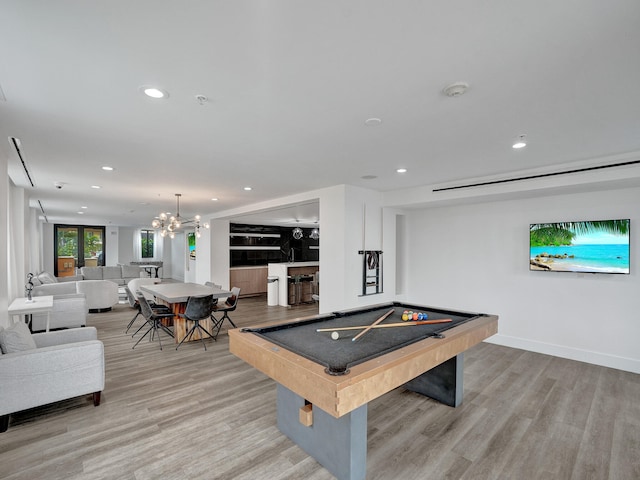 playroom featuring light wood-type flooring, a notable chandelier, and billiards