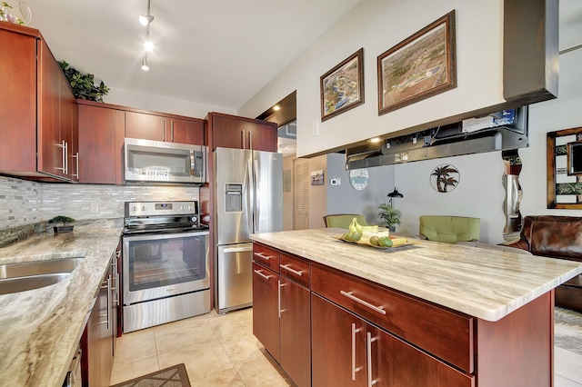 kitchen with light stone counters, light tile patterned floors, decorative backsplash, appliances with stainless steel finishes, and sink