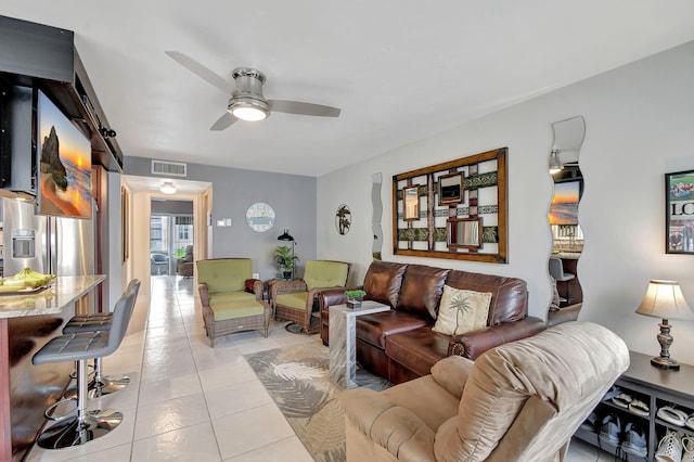 tiled living room featuring ceiling fan