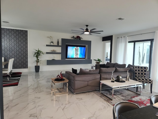 living area with a ceiling fan, visible vents, and marble finish floor