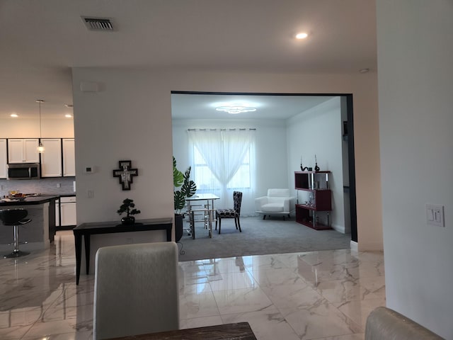 interior space featuring recessed lighting, visible vents, marble finish floor, and baseboards