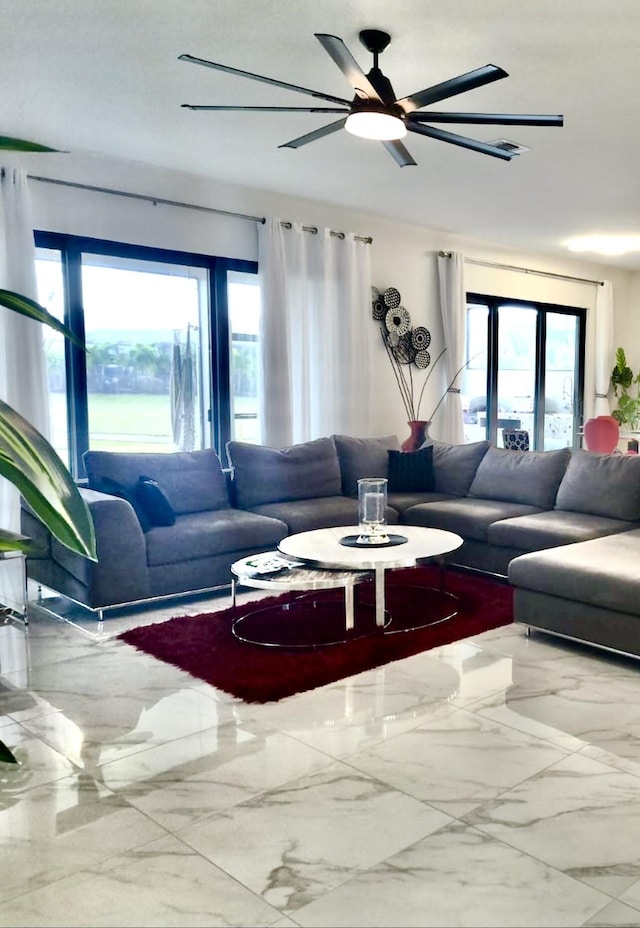 living room with marble finish floor and ceiling fan