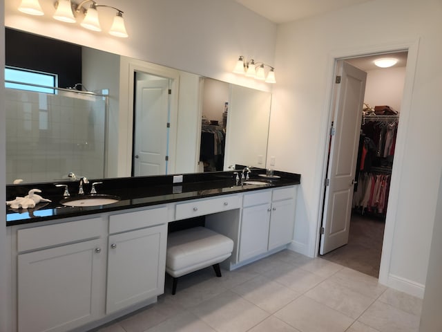 bathroom with vanity, an enclosed shower, and tile patterned flooring