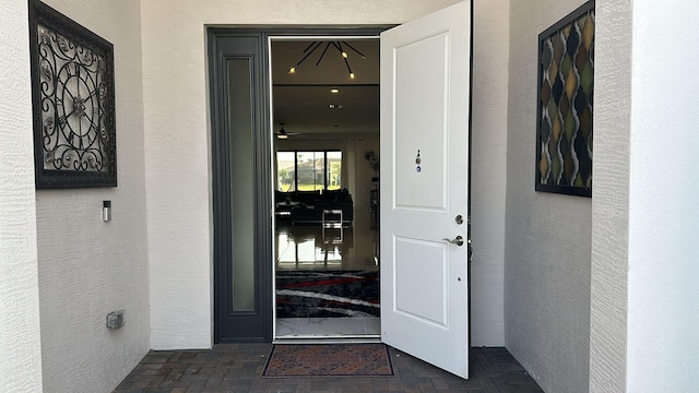 doorway to property featuring stucco siding