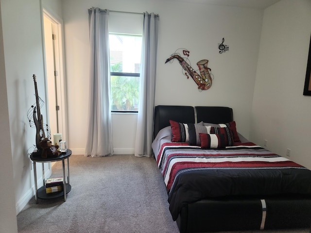 carpeted bedroom with baseboards