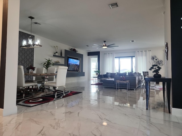 living room featuring ceiling fan with notable chandelier